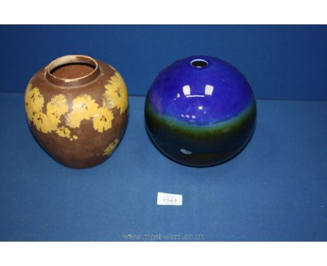 A Ming pottery brown ginger jar with yellow flowers and a blue globe ceramic vase.