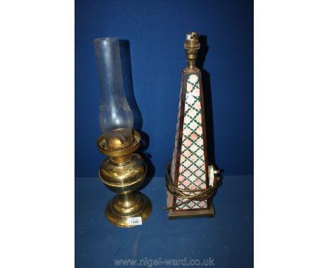 A brass oil lamp and a pyramid shaped table lamp