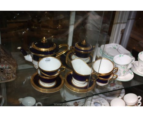 A Royal Worcester ''Diana'' Teaset in a rare cobalt blue and gilded colour-way, comprising six footed cups, saucers and tea p