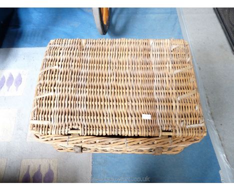 A large wicker trunk and a small leather case.