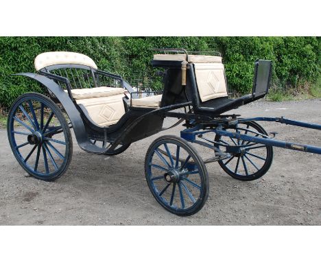 A deep Royal blue and black painted Phaeton with gold coach-lining, the swept bentwood mudguards dipping to the central iron 