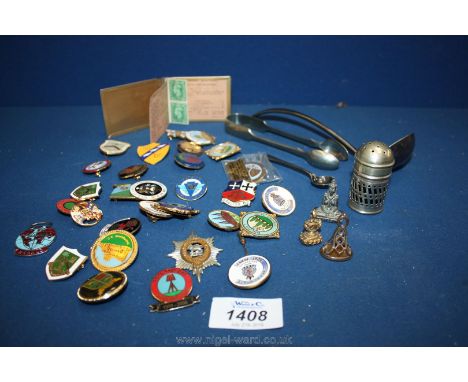 A quantity of miscellanea including badges, sugar tongs, soup ladle, etc.