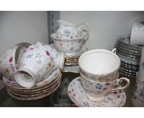 A Tuscan 'Indian Garden' pattern tea set consisting of six cups and saucers, milk jug, sugar basin, cake plates, six side pla