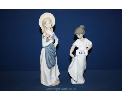 A Nao figure of a girl holding her dress and another of a girl with a bouquet of flowers.