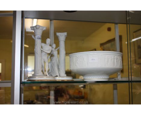 A pair of Franklin Mint fine bisque porcelain 'Romeo &amp; Juliet' candlesticks and a large footed bowl.