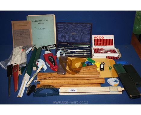 A quantity of protractors, slide rule, wooden rulers, geometry set, etc
