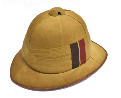A BRITISH ARMY KHAKI WOLSEY PATTERN PITH SUN HELMET  complete with leather sweatband and cloth pugaree, bearing a Royal Artil