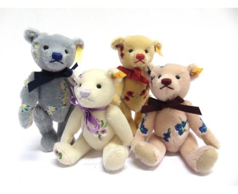 FOUR STEIFF COLLECTOR'S TEDDY BEARS  each with floral motif decoration, each 17.5cm high, unboxed. 