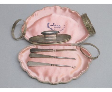 A SILVER BUTTON HOOK AND MANICURE SET TOGETHER WITH A WHITE METAL BANGLE (10.6g) AND TWO SILVER BANGLES (22g)