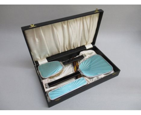 A 1920's CHROME AND GUILLOCHE ENAMEL STYLED DRESSING TABLE SET COMPRISING HAND MIRROR, HAIRBRUSH, CLOTHES BRUSH AND A LATER C