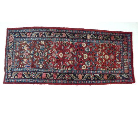 A Hamadan runner with red ground, stylised floral field, two light blue and one dark blue floral borders, 222 by 100cm. 