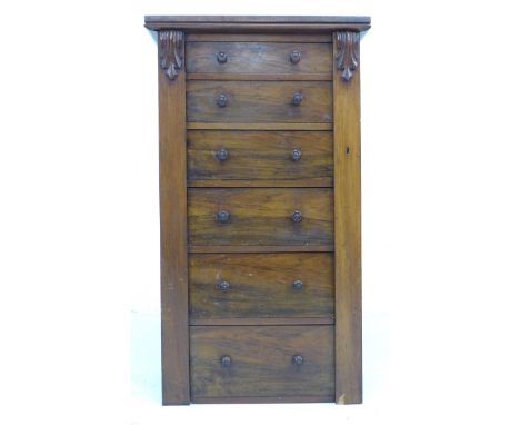 A late Victorian mahogany and rosewood veneered Wellington chest, with six graduating drawers, turned handles, hinged locking