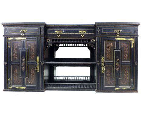 A Victorian Gothic breakfront sideboard, ebonised and gilt highlighted, three frieze drawers with bras drop handles, over a c