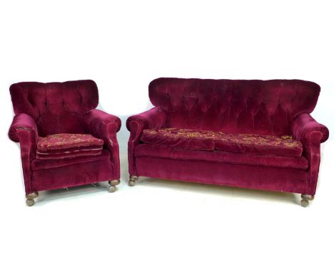 An Edwardian button back three seater sofa, 161 by 107 by 86cm high, together with a matching wing armchair, upholstered in b