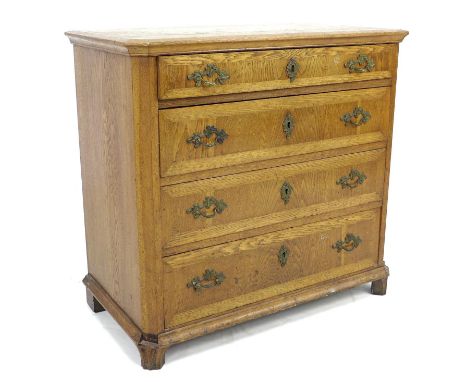 A late 19th century Danish oak chest of four graduating drawers, with brass handles and escutcheons, canted front edges, rais