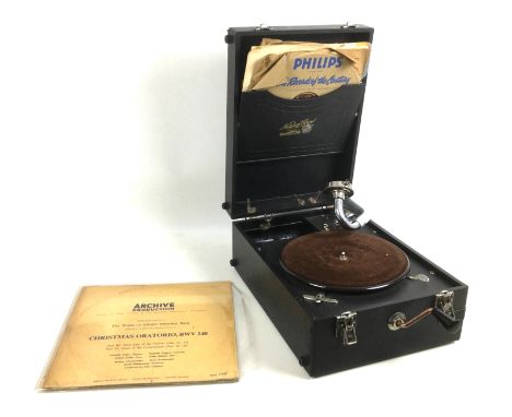 A vintage portable wind up gramophone player, with vinyl record. (2) 