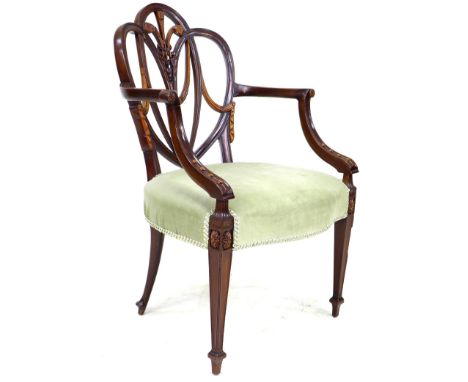 An early 19th century mahogany open arm chair, after a Hepplewhite design, with open trefoil heart shaped back decorated with