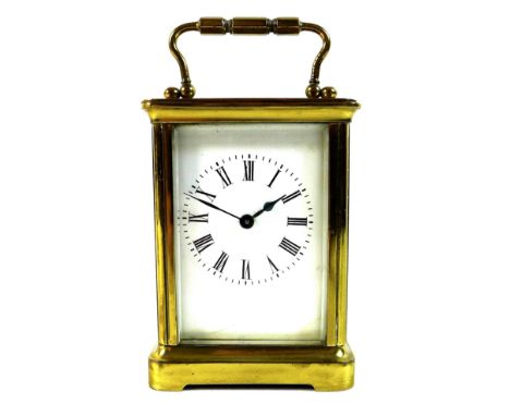 A French brass carriage clock, late 19th century, with five glass case, white dial with black Roman numerals, hinged handle t