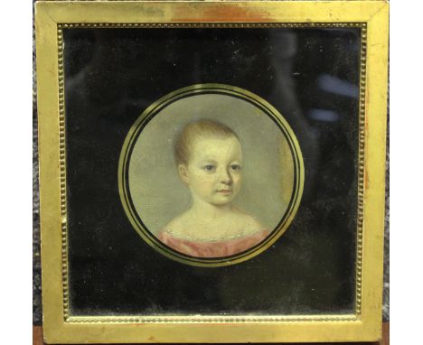 British School - Tondo Half Length Portrait of a Child, early 19th century oil, diameter 10cm, within a verre églomisé mount 