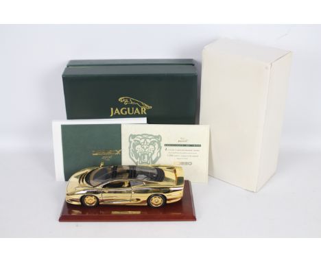 Gwilo - A boxed 1:18 scale 22ct Gold plated 1:18th scale diecast Jaguar XJ220 by Gwilo. The model which sits on wooden plinth