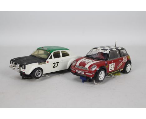 Scalextric - 2 x unboxed cars in 1:32 scale a vintage Ford Escort Mk1 RS 1600 # C.052 and a modern Mini Cooper. They both sho