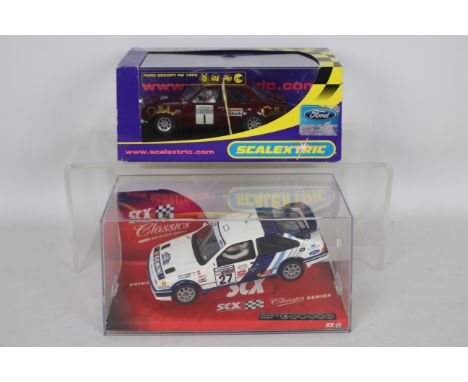 SCX - Scalextric - 2 x boxed 1:32 scale slot cars, a Ford Sierra RS Cosworth # 62470 and a Ford Escort RS 1600 # C2643. The c