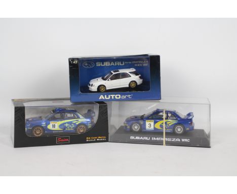 Scalextric - Saico - Autoart - 3 x boxed Subaru Impreza models including a 1:32 scale 1999 WRC slot car, a 1:32 scale 2002 WR