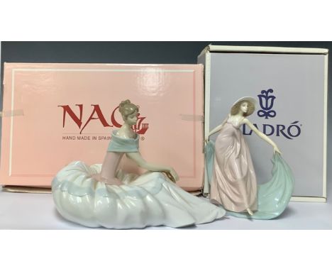 A Lladro Porcelain Figurine, Spring Dance (Tela Al Viento Azul), model no 5663, designed by Jose Puche, issued 1990, height 8