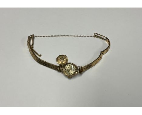 A lady's 9ct gold Rotary watch, Champagne dial, baton indicators, 21 Jewel, integral 9ct gold bracelet strap with 9ct gold St