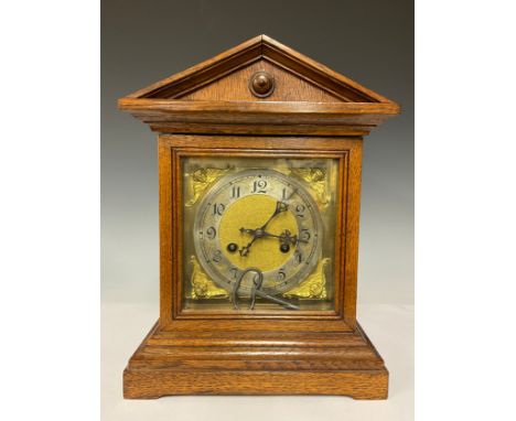 An Edwardian Oak mantle clock, square brass dial, silvered chapter ring, Arabic numerals, striking on a gong 