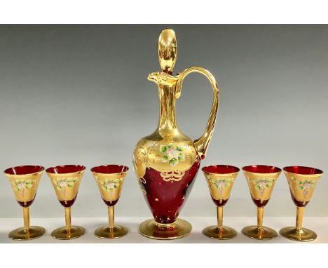 A Murano ruby glass decanter and six wine glasses, gilded and painted with flowers in relief; a large Murano ruby glass bowl,