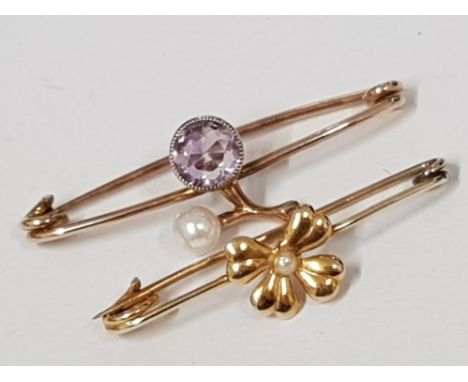 TWO ANTIQUE YELLOW METAL BROOCHES ONE WITH PURPLE STONE AND PEARL THE OTHER FOUR LEAF CLOVER 2.4G GROSS