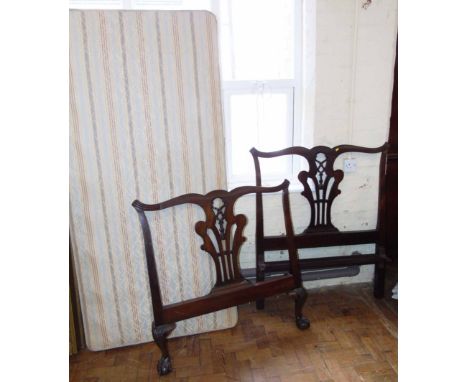 Early 20th century Chippendale style single bedstead with pierced splats, standing on ball and claw feet. Condition reports a