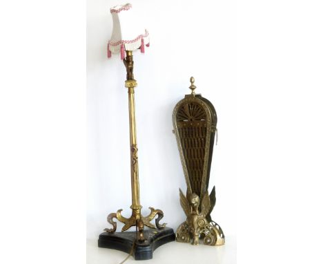 Reproduction fan shaped fire screen and a Victorian gold painted cast metal table lamp. Condition reports are not available f