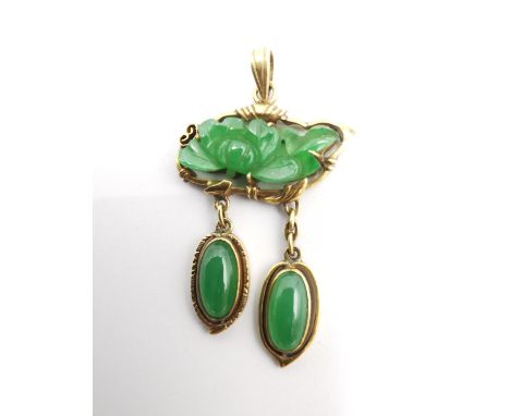 A Chinese 14 carat yellow gold an Jade articulated pendant. The central pendant a carved jade panel in the form of a lotus fl