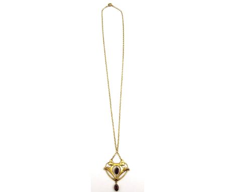 An Art Nouveau design 9 carat yellow gold garnet set pendant and chain. The pendant set with two oval mixed cut almandine gar