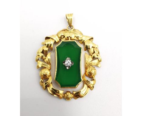 An early 20th century 14 carat yellow gold, jade and diamond pendant. The central jade panel set with a round old cut diamond