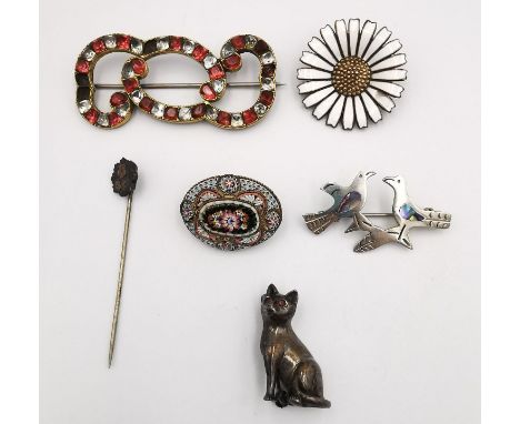 A collection of antique brooches, including a foil backed paste set red and white stone scrolling design brooch, a Anton Mich