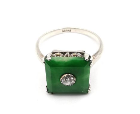 An Art Deco Chinese 14 carat white gold Jade and diamond dress ring. Set to centre of the square Jade panel is a round old cu