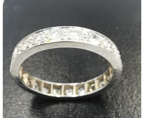 A white metal (tests as platinum) diamond set full eternity ring, set with twenty two round brilliant cut diamonds with  a to