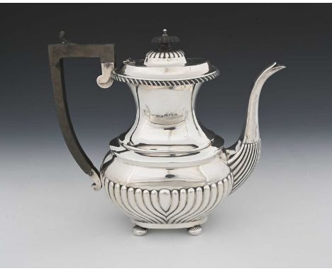 A George V silver coffee pot, of baluster form, the body decorated with semi-fluting, with gadrooned border, atop four bun fe