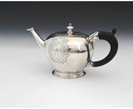 A George II silver bullet shape teapot, the body decorated with a band of flat chasing, depicting foliate scrolls on a dentil