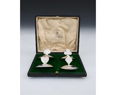 A cased set of four silver novelty Whist card holders, each surmounted with a different playing card suit, Charles Edwards, L