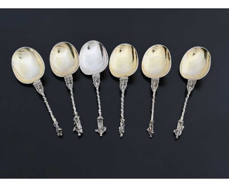 A set of six Continental silver-coloured metal apostle-style spoons, each with a cast twisted stem, surmounted by a figural f