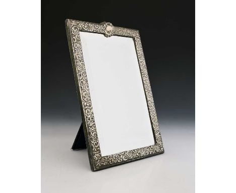 A twentieth-century silver-coloured metal dressing table mirror, of rectangular form, with an applied pressed border decorate