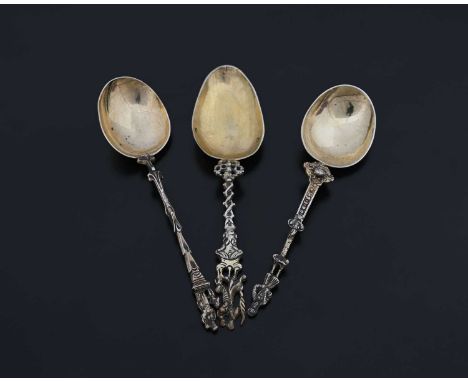 Three Continental silver-coloured metal apostle-style spoons, each with a cast stem, surmounted by a figural finial, the exte
