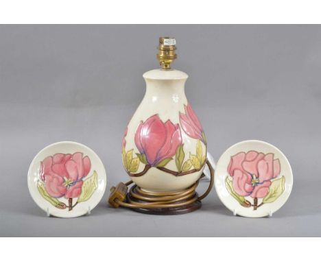 in the Magnolia pattern, 27cm high, together with two magnolia pattern dishes, one with a crack (AF) both marked to the under