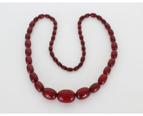 Vintage Bakelite "Cherry Amber" Beaded  Necklace. Comprising a string of graduated  oval beads.  Approx. Length: 30 in.