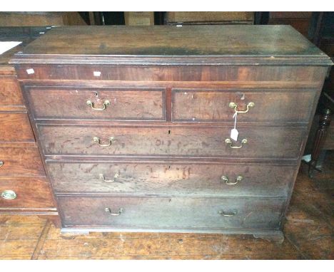 A George III oak chest of drawers, fitted with two short over three long graduated drawers, raised on bracket feet,