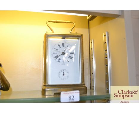A brass cased carriage clock with enamel dial and alarm movement 